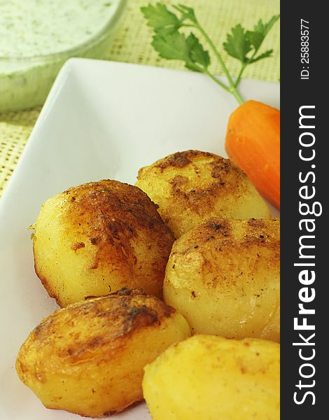 Accompanied by potatoes and carrots sautéed with green sauce