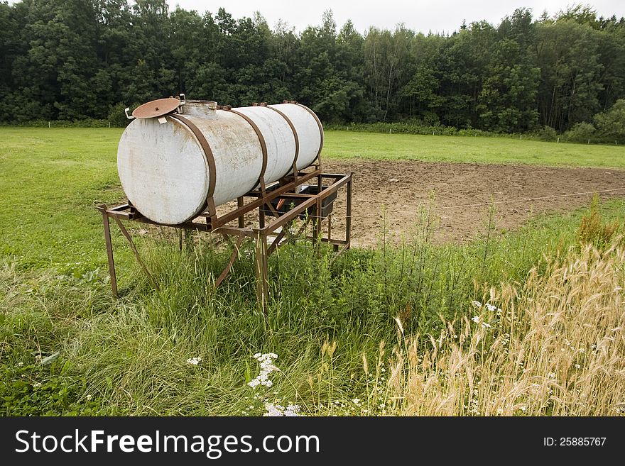 Round water tank on iron construction, water source for the field