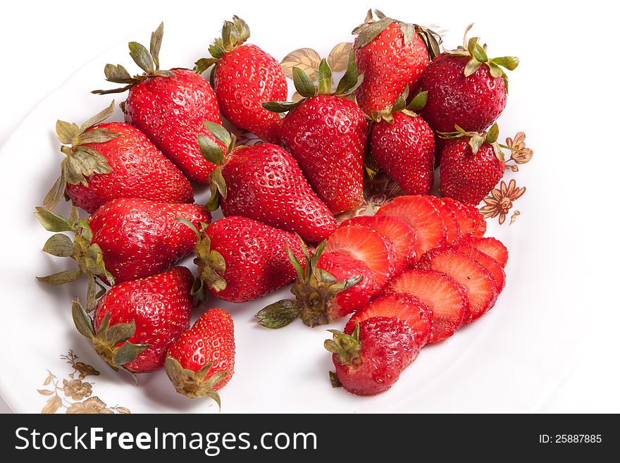 Strawberries in white dish on white background