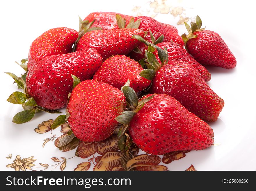 Strawberries in white dish on white background