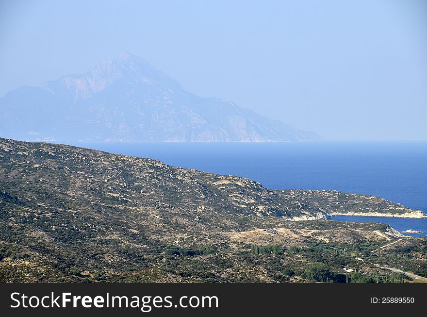 Golf beach in Sithonia peninsula of Halkidiki in Greece with view to Athos mountain. Golf beach in Sithonia peninsula of Halkidiki in Greece with view to Athos mountain