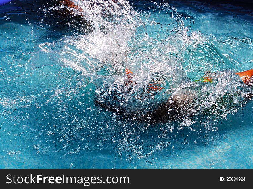 Big splash from jumping in to water. Splashing is massive and person is unrecognizable. Big splash from jumping in to water. Splashing is massive and person is unrecognizable.