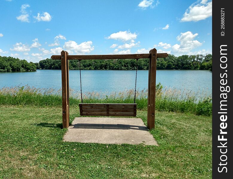 Bench overlooking a lake during the summer