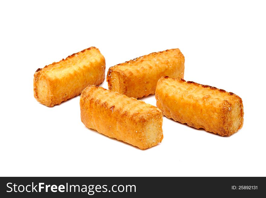 Four flaky cookies on a white background