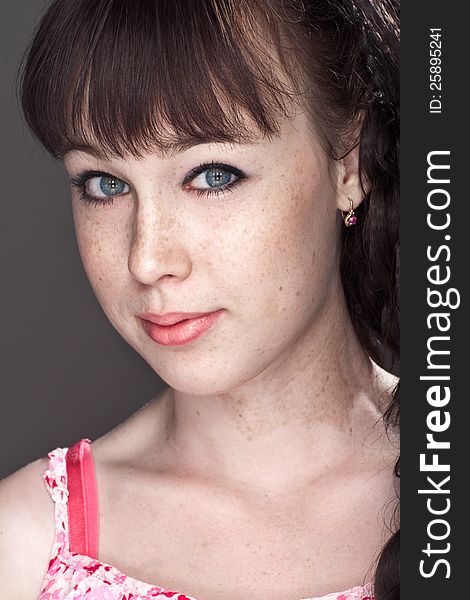 Close-up portrait of a beautiful girl with freckles. Close-up portrait of a beautiful girl with freckles