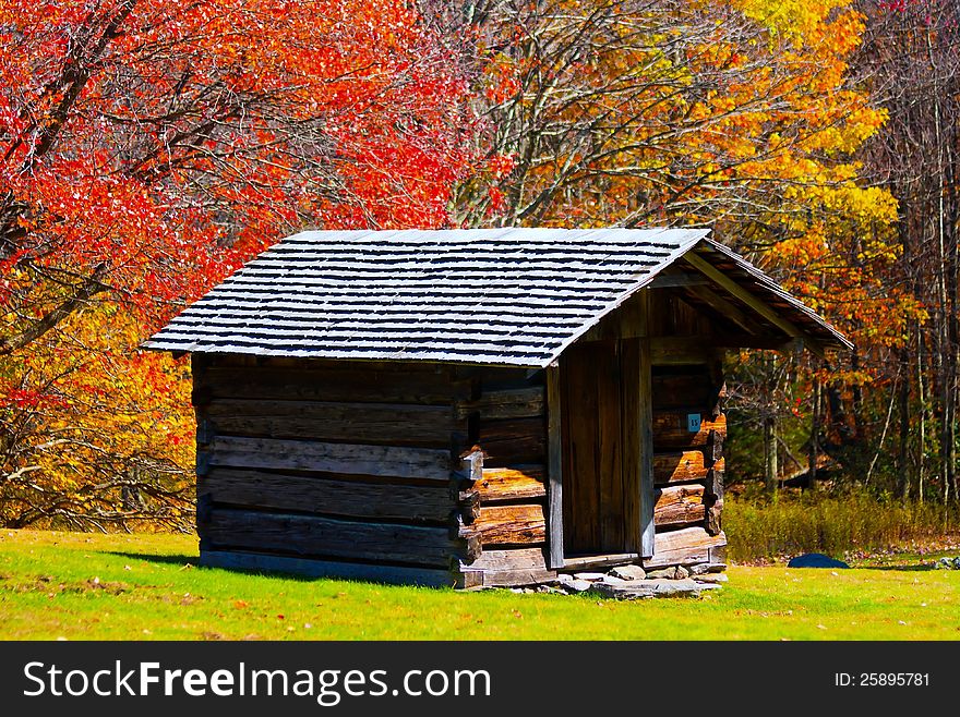 Log cabin or a hut in a autumn setting in the mountains