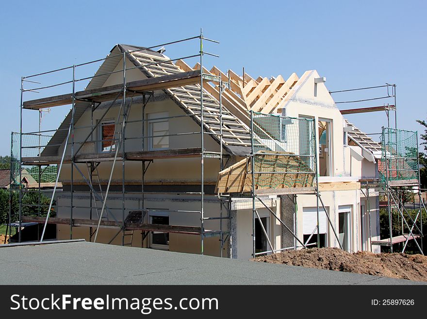 House in construction with blue sky