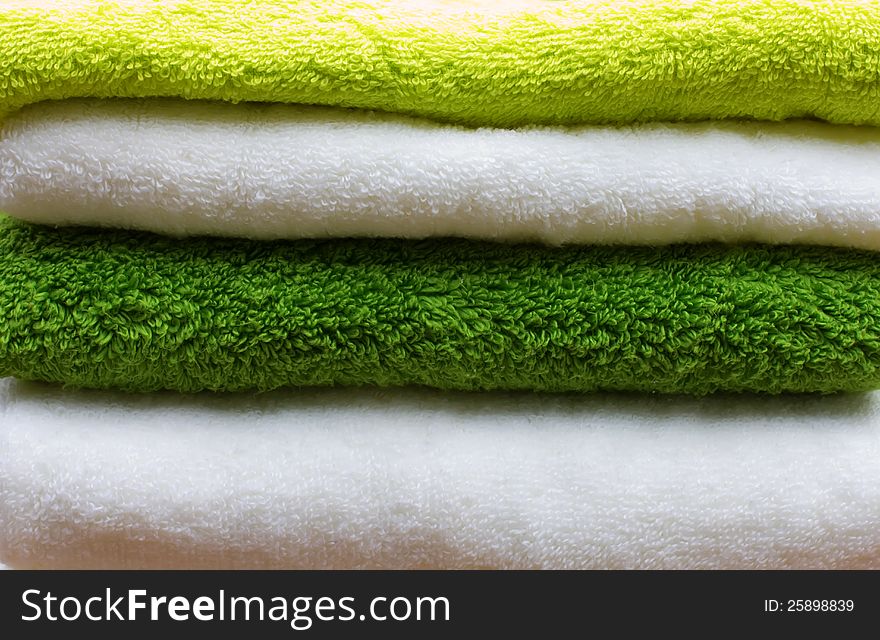 Pile of colourful white, green and lime towels. Pile of colourful white, green and lime towels