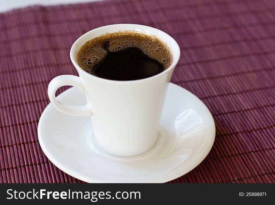 Wonderful white cup of hot black coffee on wooden background. Wonderful white cup of hot black coffee on wooden background