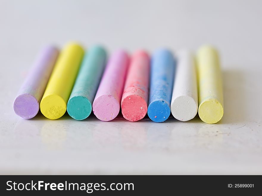 Colourful sticks of chalrs on metallic surface. Colourful sticks of chalrs on metallic surface