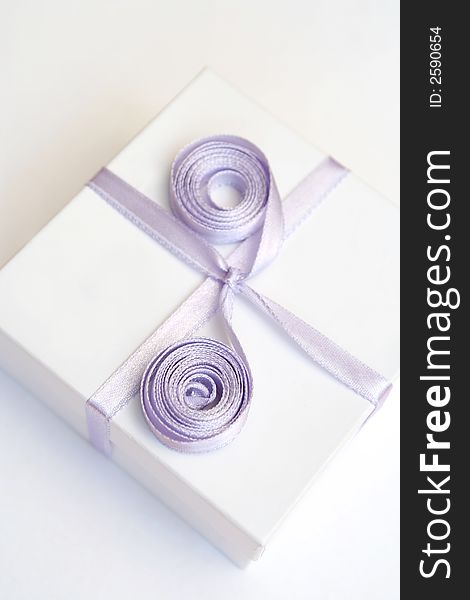 Gift in a white box with a lilac tape