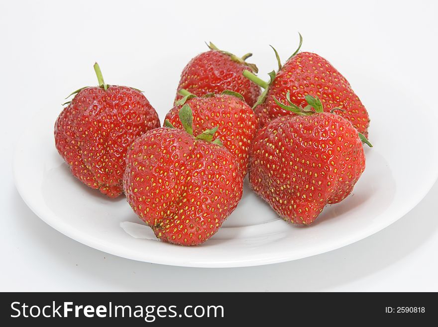Strawberries on the plate isolated