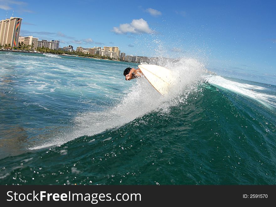 A shortboard surfer surfing on a beautiful wave in hawaii. A shortboard surfer surfing on a beautiful wave in hawaii