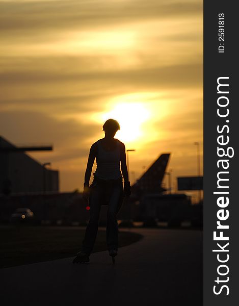 Silhouette of a activ woman is running on roller blades. Silhouette of a activ woman is running on roller blades