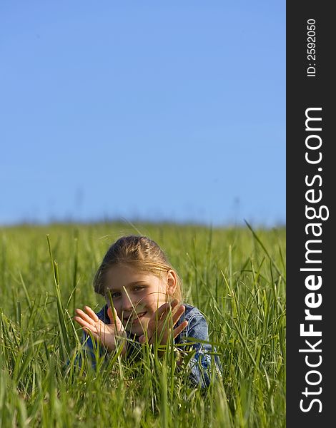 The girl lays on a grass. The girl lays on a grass