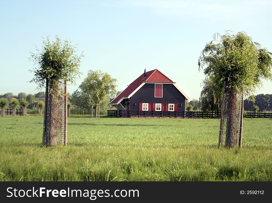 Little farm with trees and pale blue sky. Little farm with trees and pale blue sky