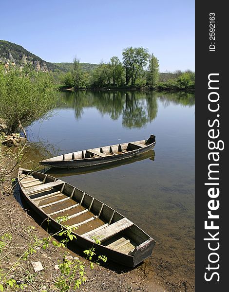 Two rowing boats moored on the riverbank