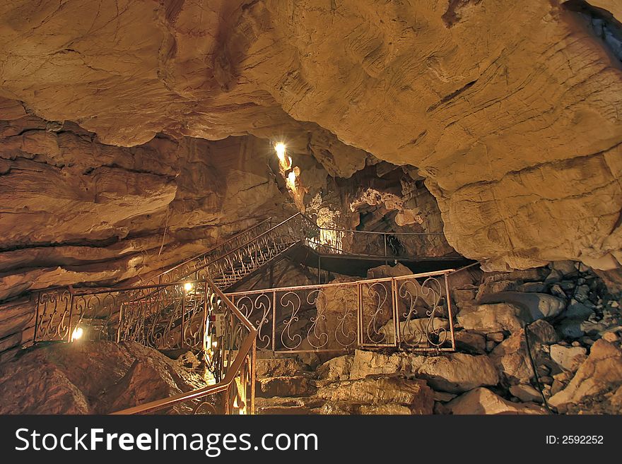 Limestone cave with stairs and handrail. Limestone cave with stairs and handrail