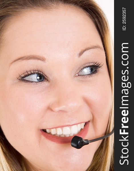 A smiling telesale girl using a headset. A smiling telesale girl using a headset