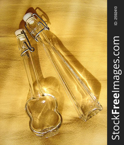Bottles of glass with yellow reflection