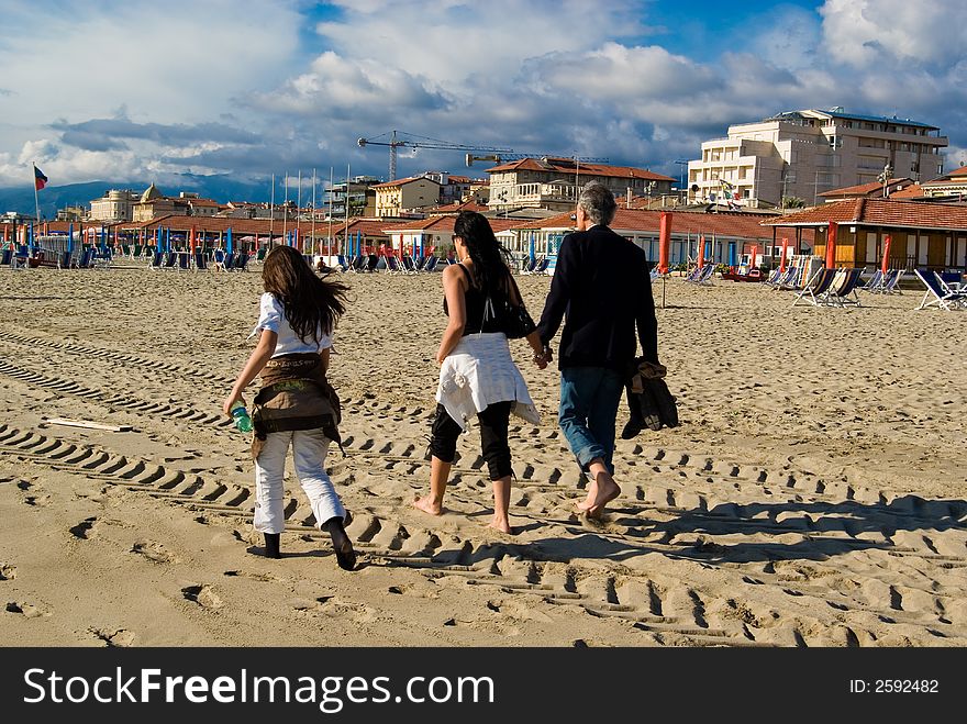 Happy family has a stroll on the beach. Happy family has a stroll on the beach