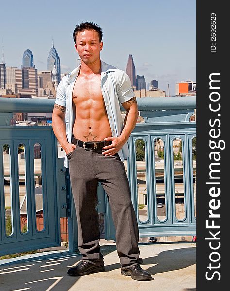 A young well built man in front of the Philadelphia skyline. A young well built man in front of the Philadelphia skyline