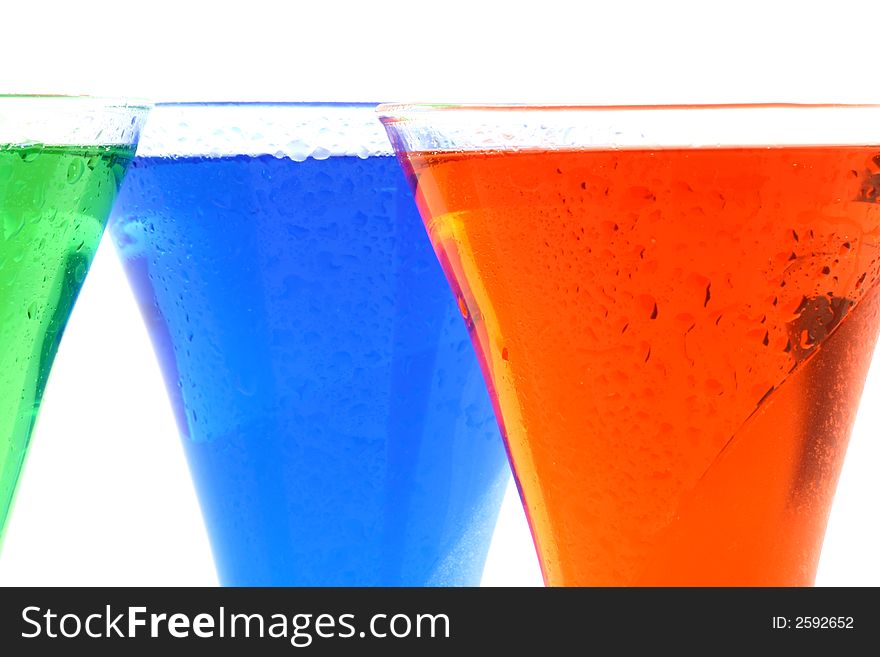 Colourful drinks in red green and blue standing together. Colourful drinks in red green and blue standing together