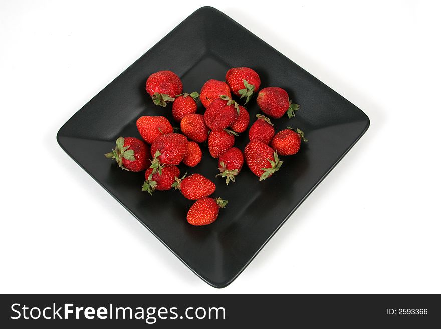 Strawberries on Black Plate over White