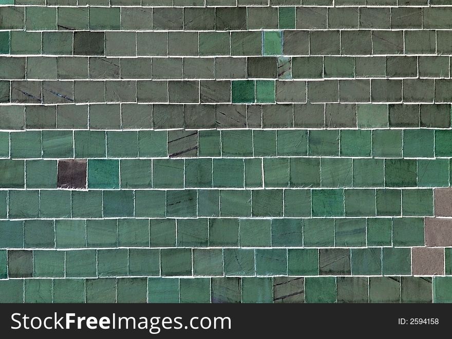 Abstract wall of green slates. Slates are often used in the building industry to cover the sides of buildings to protect them from driving rain. Abstract wall of green slates. Slates are often used in the building industry to cover the sides of buildings to protect them from driving rain.