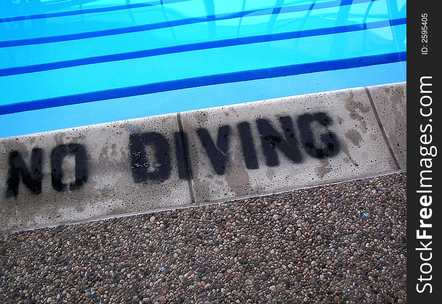 Warning sign on the shallow end of pool