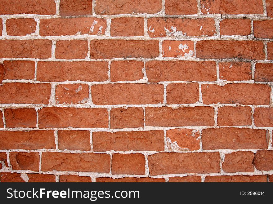 Old, destroyed by time and a rain, a brick wall