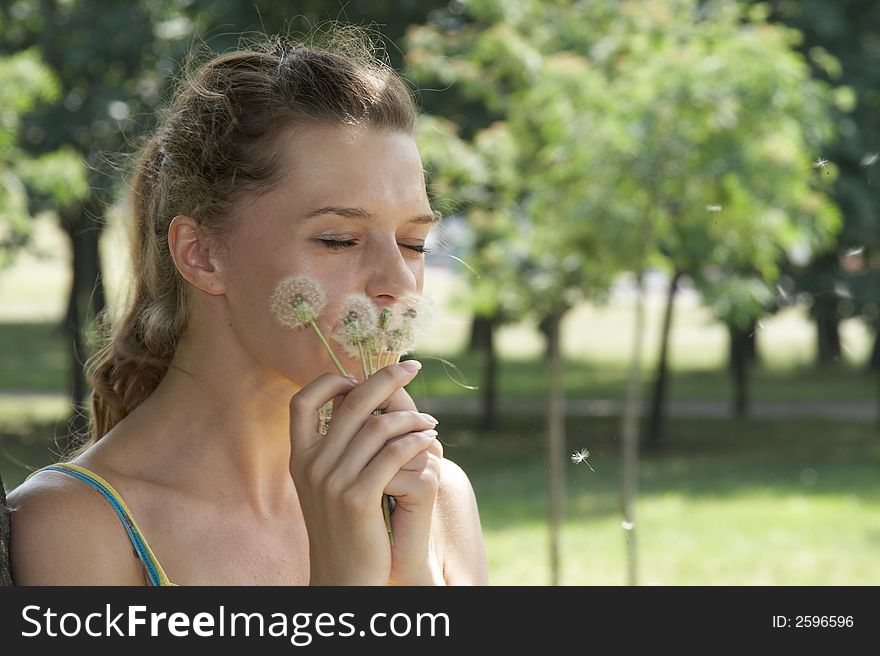 The girl and a dandelion. The girl and a dandelion