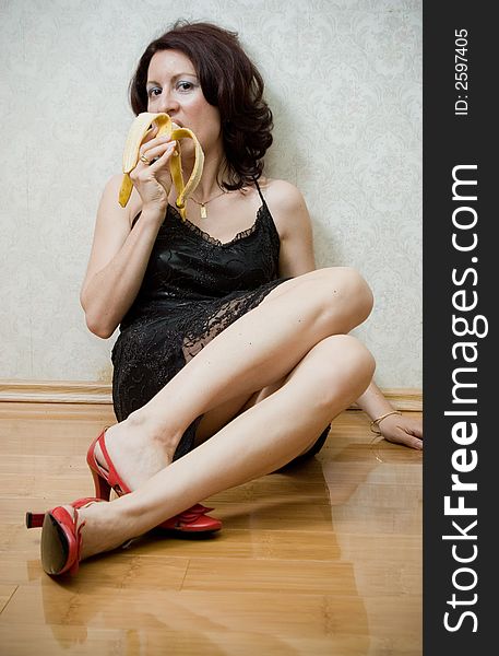 Beautiful mid thirties woman with a banana. Beautiful mid thirties woman with a banana
