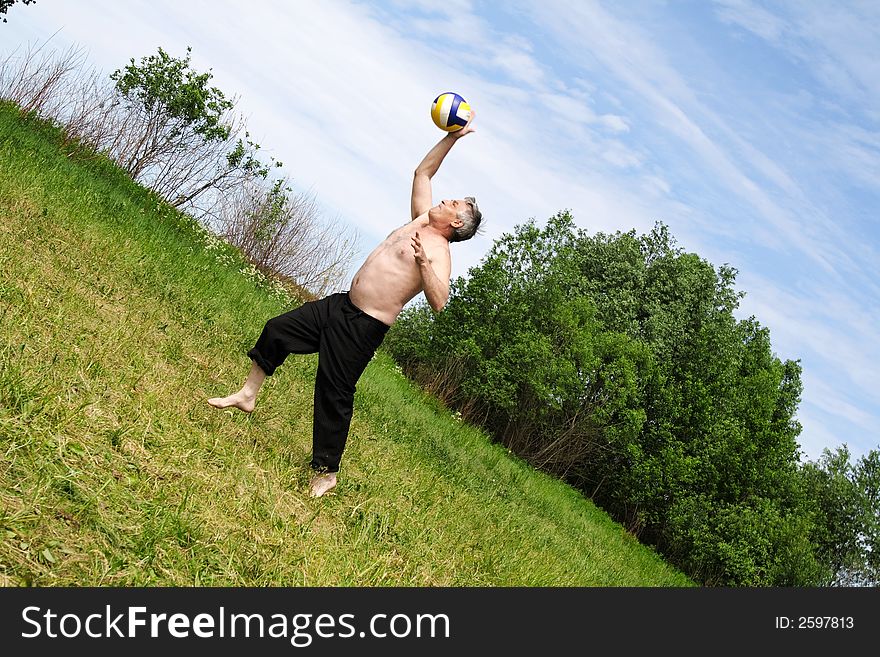 The man in park plays with a ball