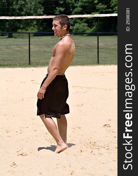 Young college age male playing volleyball on summer break. Young college age male playing volleyball on summer break.