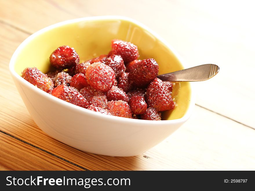 Sugared strawberries in a yellow bowl