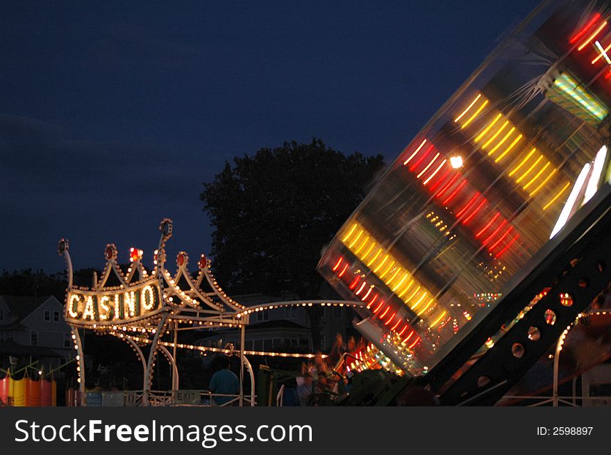 Rides at an amusement park illuminated at night. Rides at an amusement park illuminated at night.