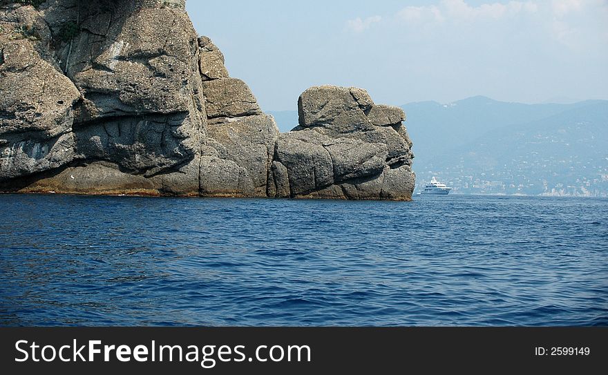 Yacht Behind Rocks
