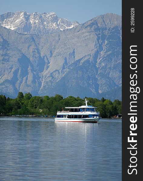 Motor ship in Alps lake with mountains background. Motor ship in Alps lake with mountains background