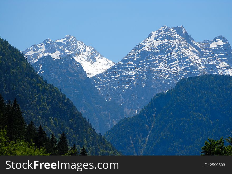 Two snow Alps peaks on the sky background. Two snow Alps peaks on the sky background