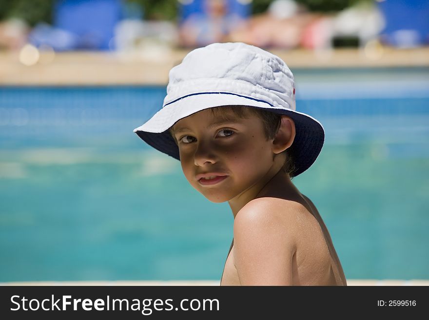 Portrait of the boy beside swimming pool