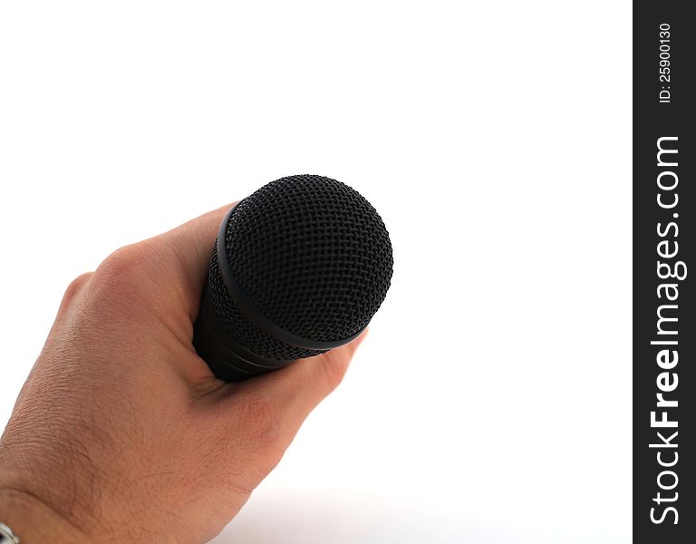 Hand with microphone over white, symbolic for public singing, speaking...