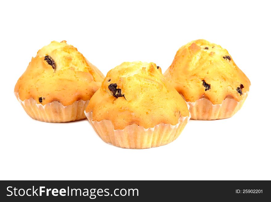 Three raisin muffins isolated on a white background