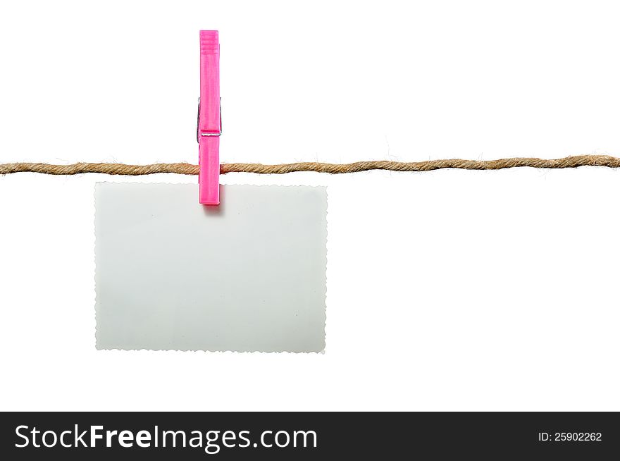 A blank photo hanging on a rope held by a clothes peg on a white background with copy space. A blank photo hanging on a rope held by a clothes peg on a white background with copy space