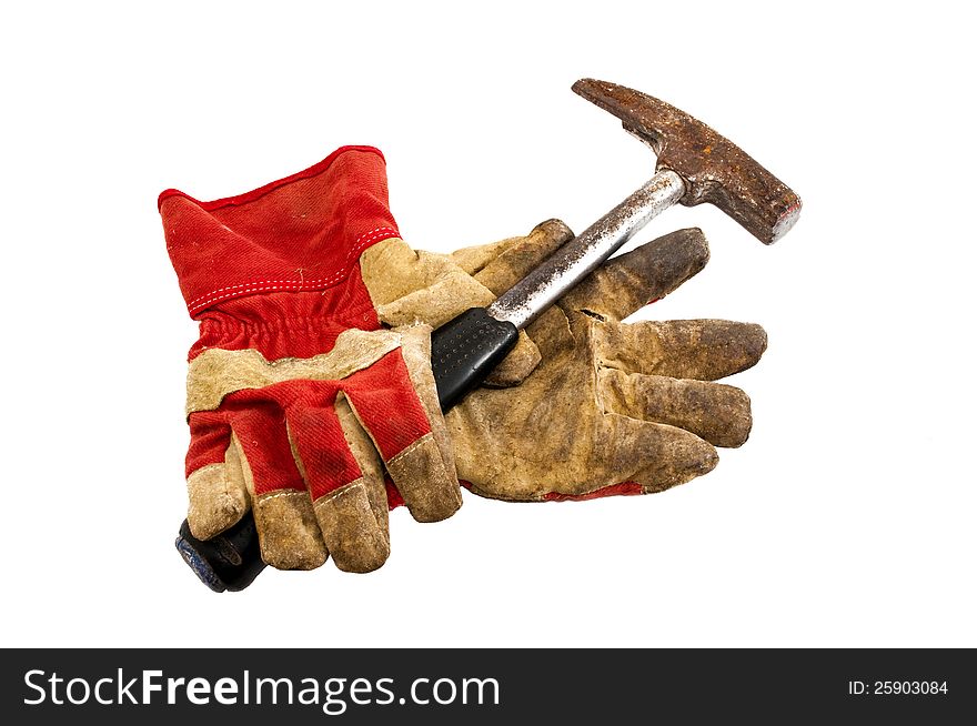 Old work gloves and a hammer on a white background