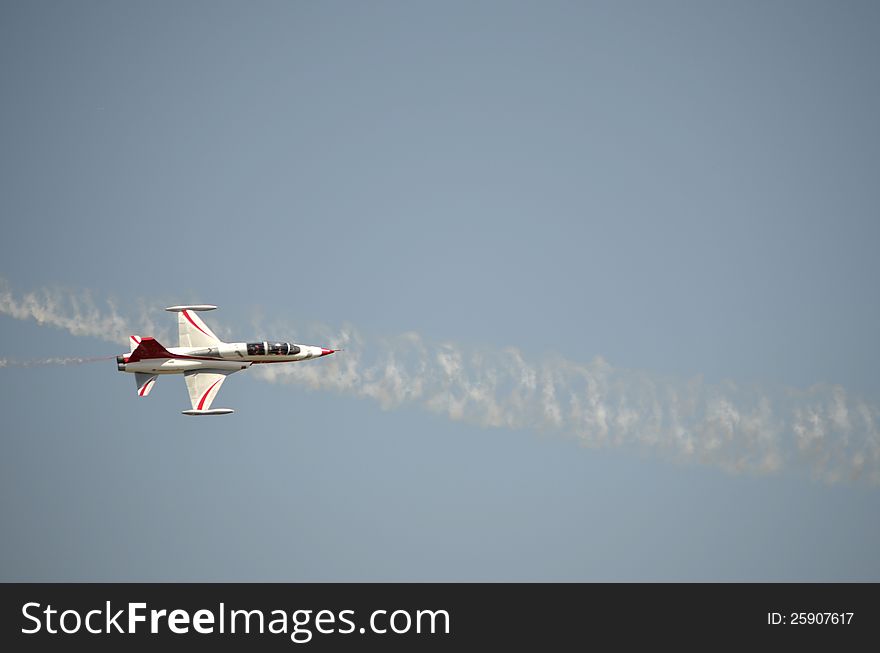 A plane demonstrating its acrobatics at an Air Show. A plane demonstrating its acrobatics at an Air Show