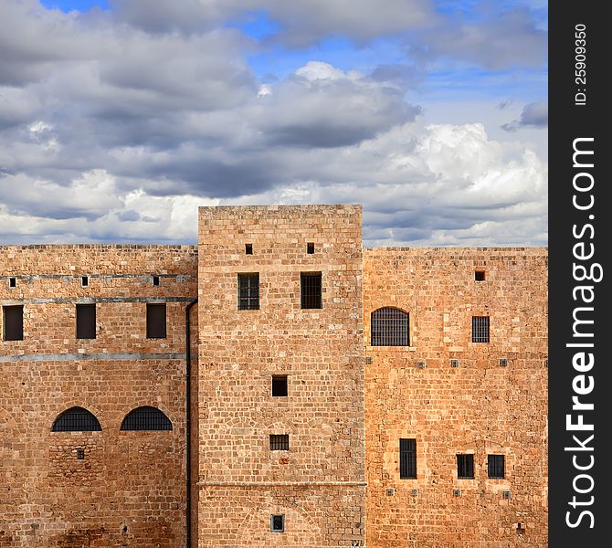 Old Middle East prison against expressive cloudy sky. Old Middle East prison against expressive cloudy sky