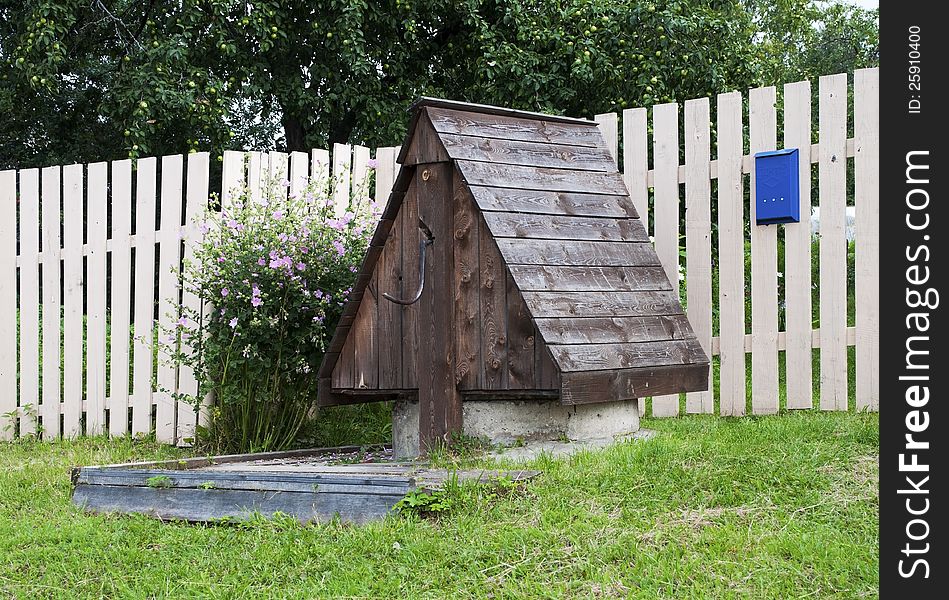 Country wooden well near the house. Country wooden well near the house