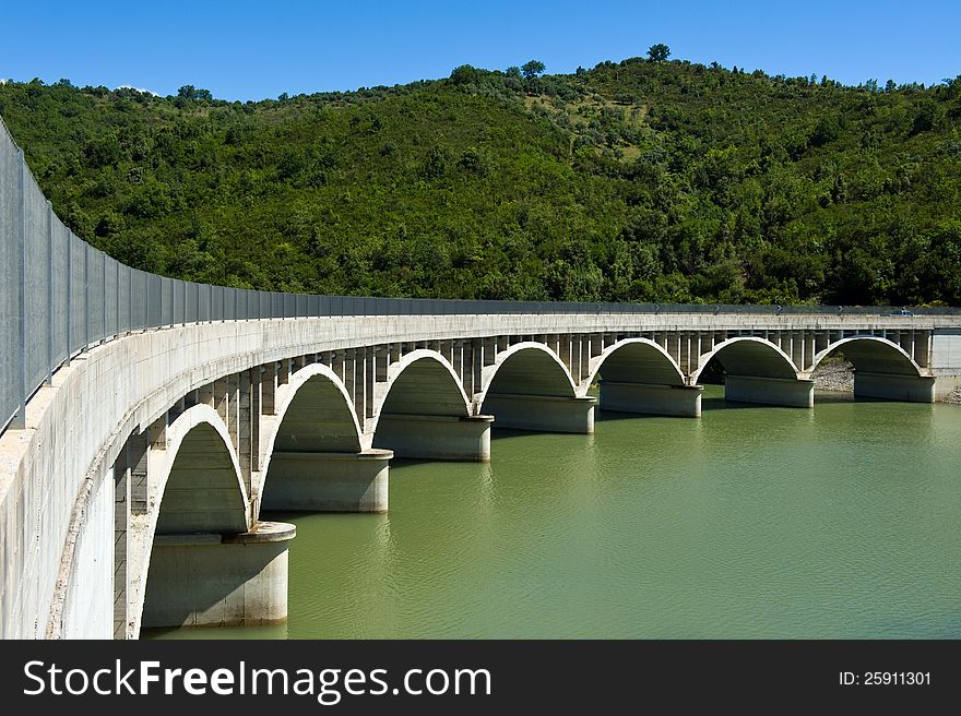 Arched bridge over the dam Alento