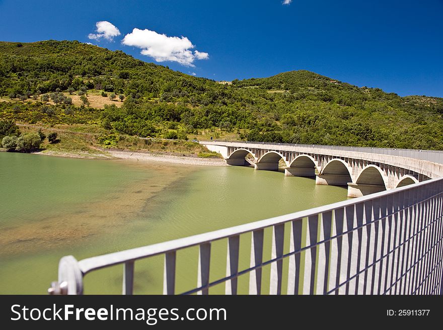 Arched bridge over the dam Alento